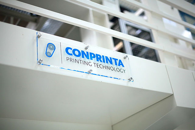 Glass sign with company logo on a Conprinta IMD flexo printing system.