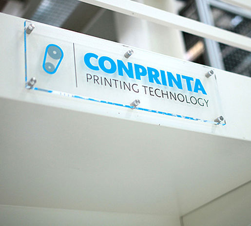 Glass sign with company logo on the CONPRINTA IMD flexographic printing press.
